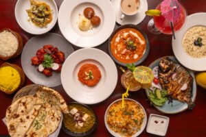 Overhead spread of Indian curries, rice, naan, desserts and drinks at Indian Spice